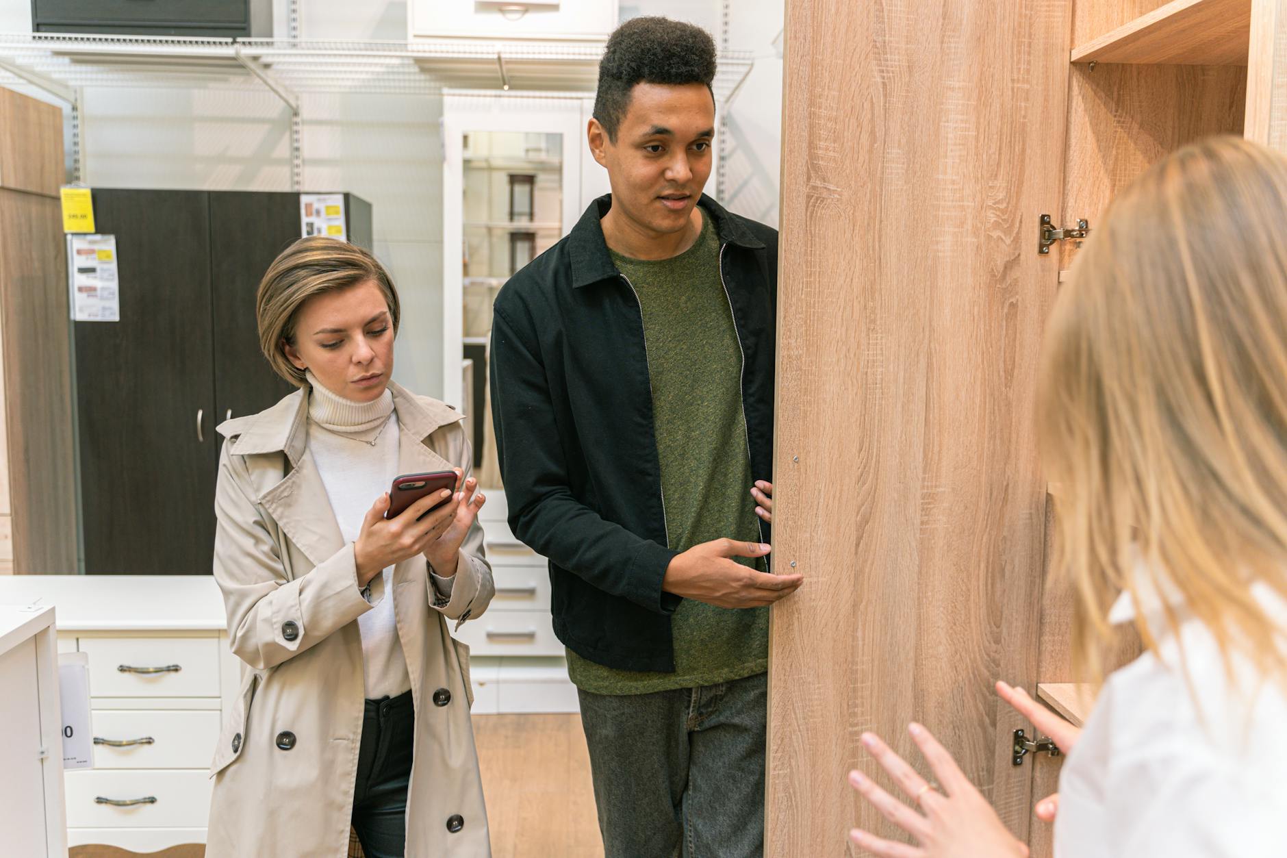 Para ogląda drewniane meble w nowoczesnym salonie sklepowym